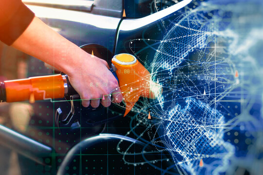Fuel pump nozzle refueling a car with digital globe, market charts and data overlay. Fuel prices, energy market, transportation and oil industry concept for business and finance marketing.