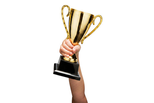 Winning hand raising a golden trophy cup high in celebration