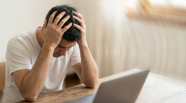 Stress anxiety frustration burnout headache tired overworked depression male adult man Stress anxiety frustration burnout headache tired overworked depression male adult man sitting desk with