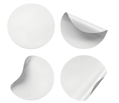 Collection of four white circular adhesive paper sticker mockups featuring curled corners and realistic soft drop shadows.