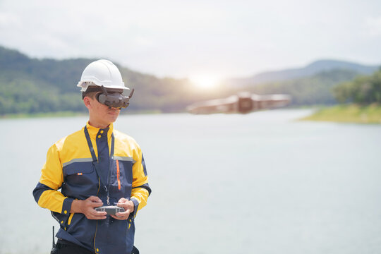 Engineer Wearing FPV Goggles Flying Drone for Outdoor Environmental Water Survey