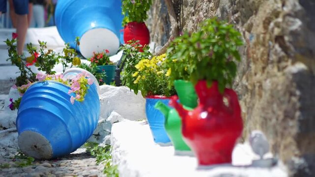 Charming Greek outdoor seating with blue chairs and white steps in a peaceful setting in slow motion 60fps