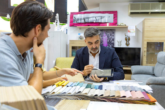 Interior designer discussing furniture options with client