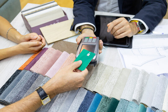 Customer making card payment for interior design services