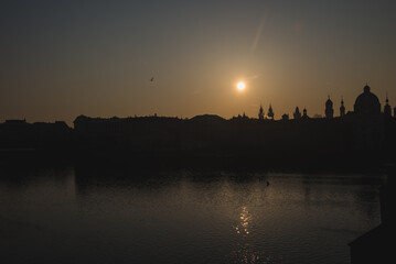 Naklejka premium Sunrise silhouette of Prague Old Town skyline over Vltava River