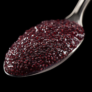 Closeup of spoon filled with chia seeds isolated on black background with clipping path, concept of nutrition and healthy eating