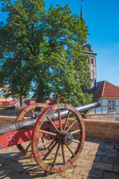 Ancient cannon with Tallinn coat of arms against Niguliste church with copy space
