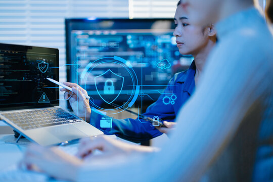 Female cybersecurity professional working with laptop and digital security interface, shield and lock icons, representing data protection, privacy