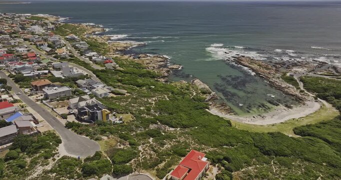 Gansbaai South Africa Aerial v27 flyover around Stanford's Cove beach and De Kelders residential townscape beneath coastal mountains - Shot with Mavic 3 Pro Cine - Jan 8th 2024