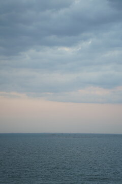 Clam ocean beneath a dramatic cloudy sky 