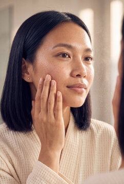 Young woman touching her face in the mirror morning skincare routine portrait for beauty banner and skincare product design