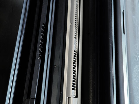 Several modern laptop computers stacked side by side showing USB ports and aluminum chassis. Technology comparison, computer hardware, office equipment and digital devices concept.
