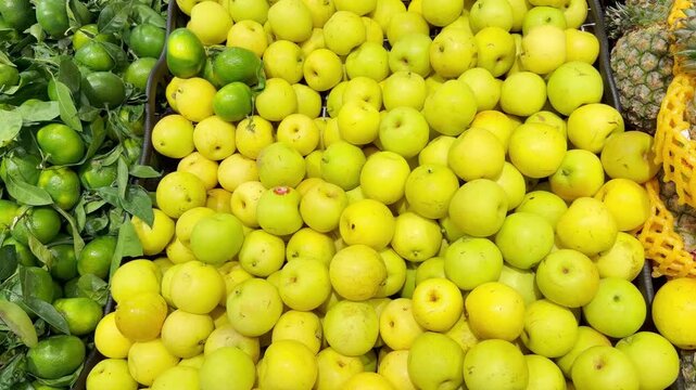 Fresh Tropical Fruits on Display in Supermarket Produce Section &ndash; Assorted Mangoes, Dragon Fruit and Passion Fruit Stacked at the Vegetable Counter