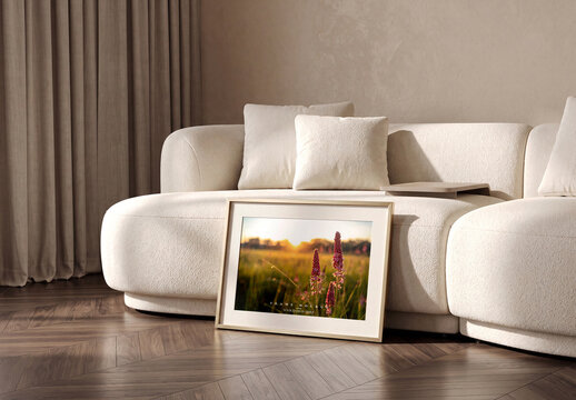 Photo Frame Mockup Leaning on Floor Against White Sofa in Living Room