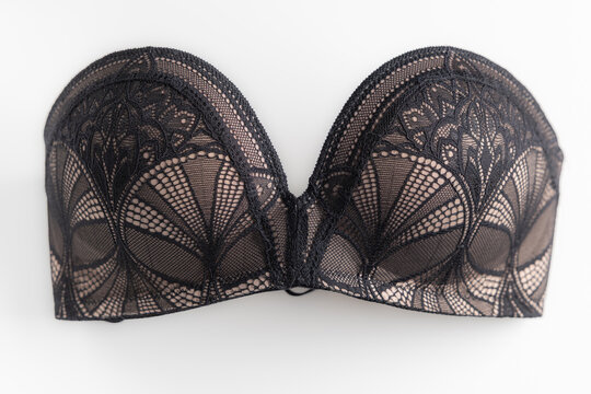 Black lace bra with beige padded cups isolated on white background