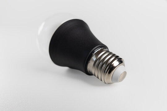 Modern LED light bulb with black body isolated on white background