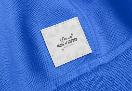 Square Clothing Label Patch Tag Mockup on Blue Sweatshirt Fabric