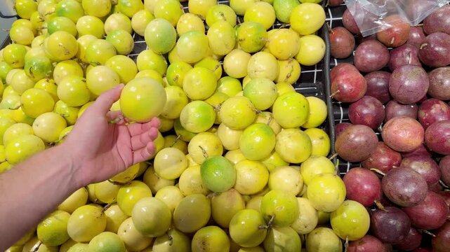Fresh Tropical Fruits on Display in Supermarket Produce Section &ndash; Assorted Mangoes, Dragon Fruit and Passion Fruit Stacked at the Vegetable Counter