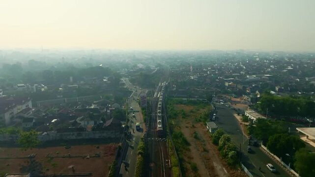 Hazy aerial panorama of railway corridor across urban Yogyakarta