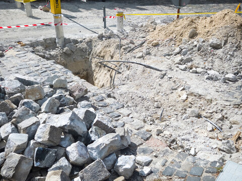 Construction Cobblestone Excavation Trench Street Repair Urban Infrastructure Stone Pile Caution Renovation Road Site Work