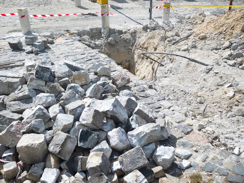 Construction Cobblestone Excavation Trench Street Repair Urban Infrastructure Stone Pile Caution Renovation Road Site Work
