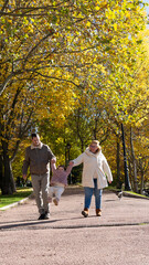 Fototapeta premium Family walking having fun in autumn park