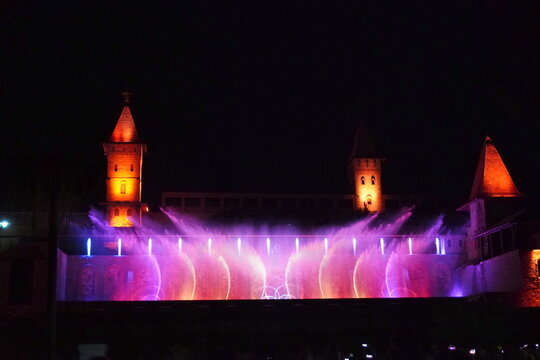 Colored musical fountains in the city park. Night time.