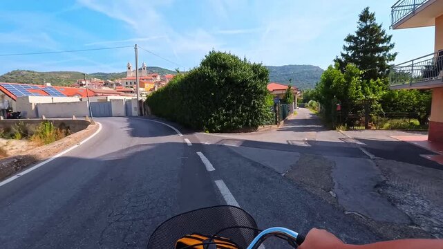 Riding Old Squeaky Bicycle on village street with Hilltop Church and Mountain in Background, Borgio Verezzi, Italy - POV VIDEO