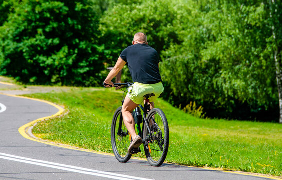 Cyclist ride on the bike path in the city Park