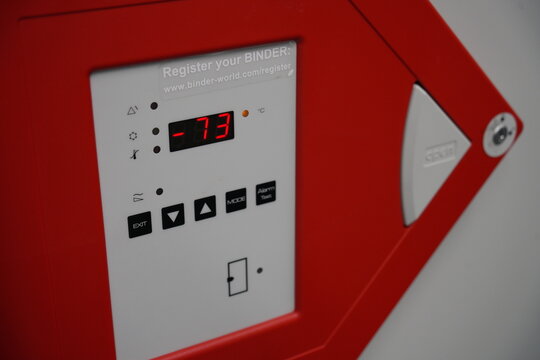 A control panel of an ultra low temperature freezer shows minus seventy three degrees.