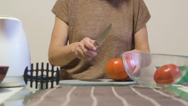 Woman Pouring Boiling Water from Kettle to Blanch Tomatoes in Glass Bowl for Peeling