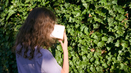 Fototapeta premium Child Viewing Solar Eclipse with Pinhole