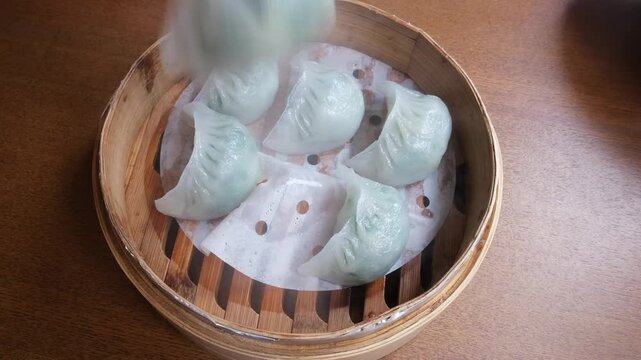 Steamed Korean dumplings filled with pork and vegetables, close-up image.