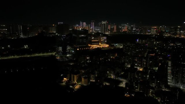 illuminated Corporate offices with background skyscrapers and Residential area at lanco hills, manikonda, hyderabad, telangana, india. night time, push in shot, drone shot, 4k.