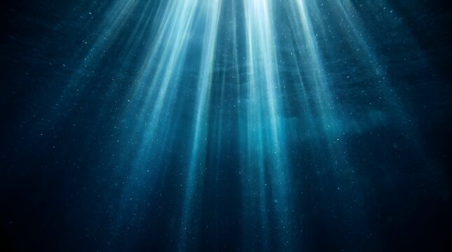 Deep blue underwater light rays with floating particles effect.