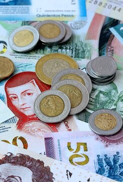 Mexican peso money banknotes and coins on table. Mexico cash bills of MXN currency