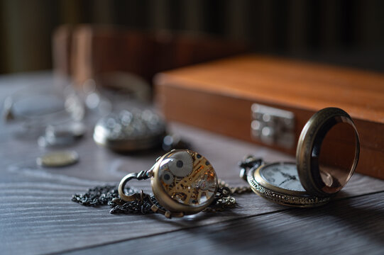 composition of vintage watch with glass lid and mechanic watches on the old grey table