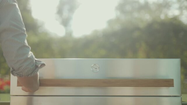 Close-up of modern outdoor kitchen drawer with wooden handle