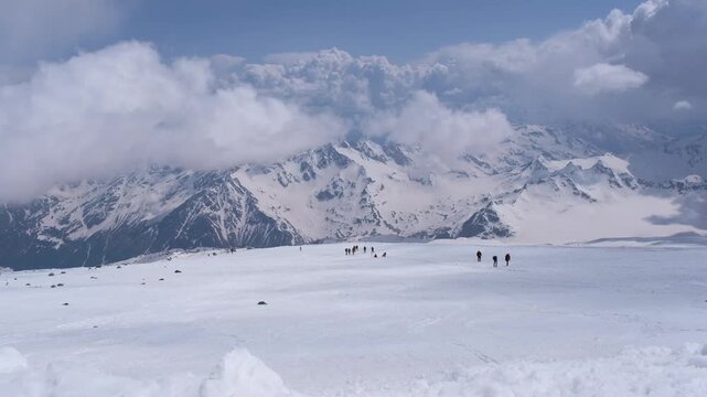 Climbers on the slopes of Mount Elbrus with the Semerka Glacier and Mount Ushba in the background