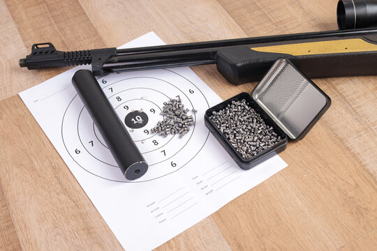 Closeup View of Scoped Weapon Muzzle and Scattered Metal Pellets Directly on Paper Target