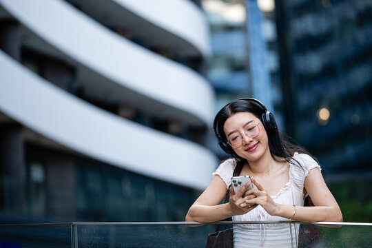 Young woman enjoying music with headphones and smartphone