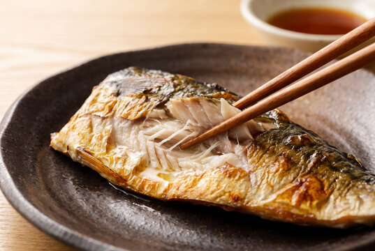 Chopsticks Lifting Flaky Grilled Spanish Mackerel Meat