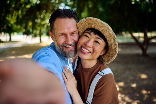 Smiling Couple Taking Selfie Together In Park &mdash; Asian Woman And Man Enjoying Summer Romance