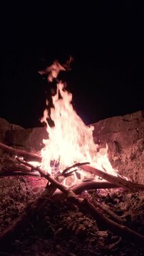 Slow Motion Campfire Burning Brightly in Stone Fire Pit at Night