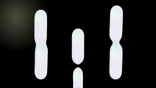 Abstract Floating Soft Capsule Shapes on Black Background