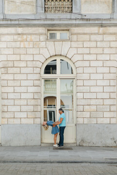 Couple dancing outside an arched doorway in the city