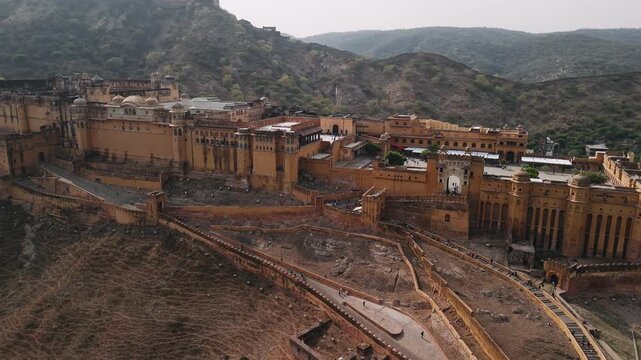 Amber fort aerial view in jaipur revealing the majestic palace and walls nestled in the aravalli hills of rajasthan, india