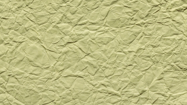 Light yellow green crumpled paper texture background with wrinkled surface and natural fold pattern