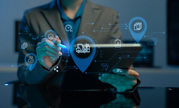 logistics operator using GPS radar and real-time fleet management dashboard on computer.