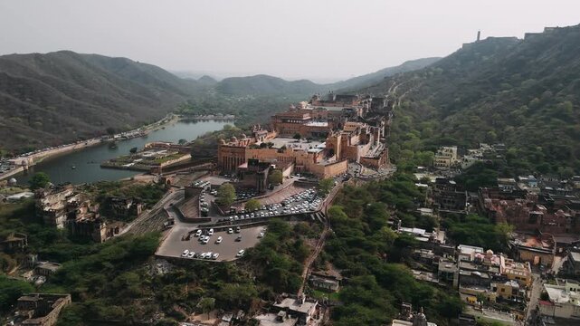 Aerial view of the historic amber fort, amer palace, and maota lake in jaipur, rajasthan, showing ancient indian architecture